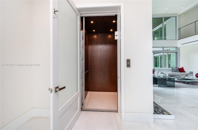 6301 SW 114th St, Pinecrest, FL 33156 - hallway with elevator and floor to ceiling windows