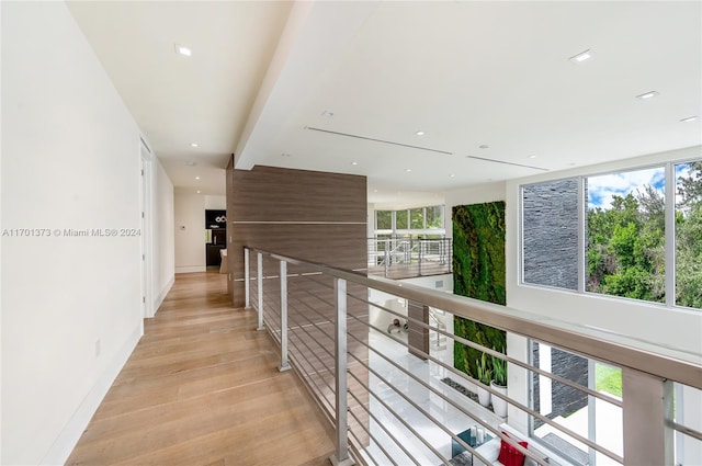 hallway with light hardwood / wood-style floors