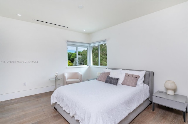 bedroom with hardwood / wood-style flooring