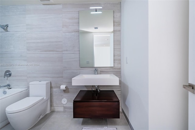 full bathroom featuring bathing tub / shower combination, sink, tile walls, and toilet