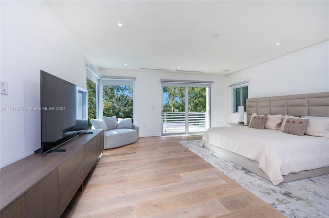 bedroom with light wood-type flooring and access to outside