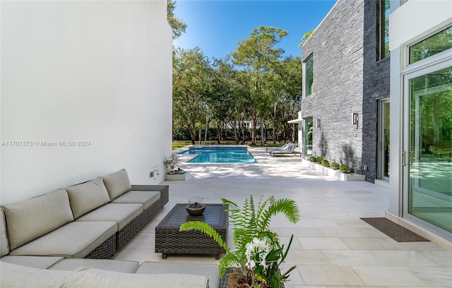 view of pool with a patio and an outdoor hangout area