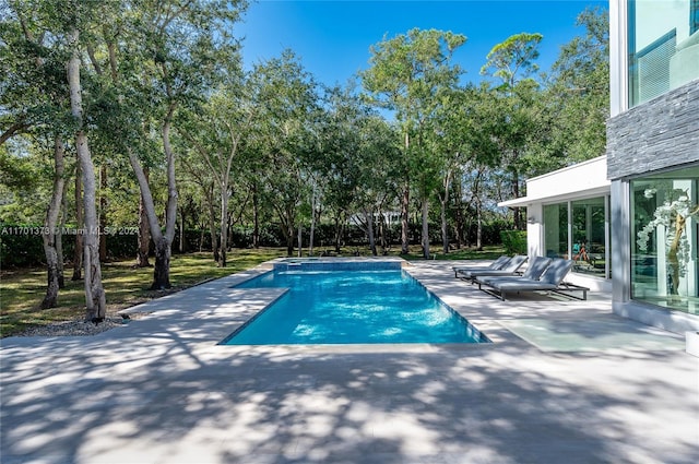 6301 SW 114th St, Pinecrest, FL 33156 - outdoor pool featuring a patio and view of scattered trees