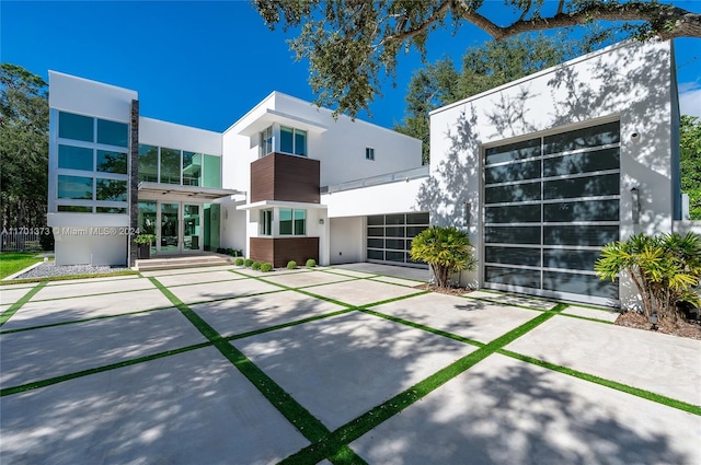 6301 SW 114th St, Pinecrest, FL 33156 - rear view of property with stucco siding, concrete driveway, and a garage