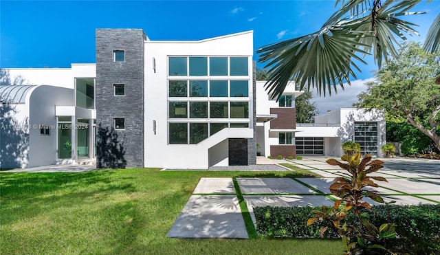 6301 SW 114th St, Pinecrest, FL 33156 - back of house with stucco siding, a lawn, and stone siding