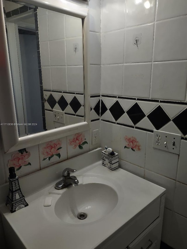 bathroom featuring vanity and tile walls