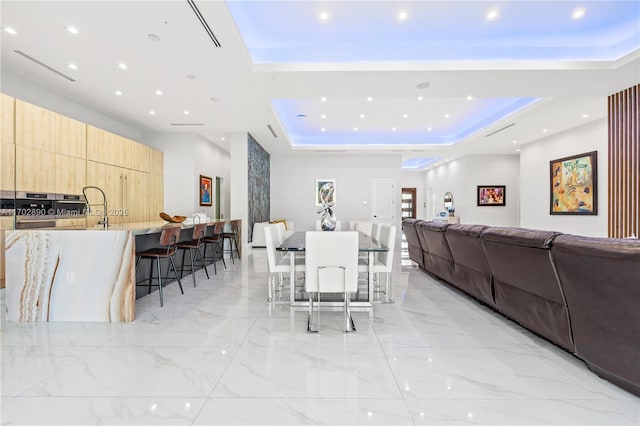 dining space featuring a tray ceiling