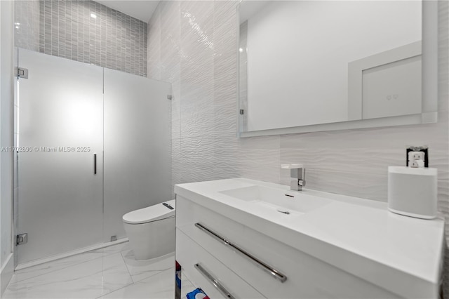 bathroom with an enclosed shower, vanity, toilet, and tile walls