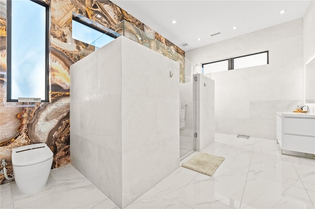 bathroom with vanity, toilet, an enclosed shower, and tile walls