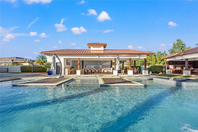 view of swimming pool featuring a patio and an outdoor bar