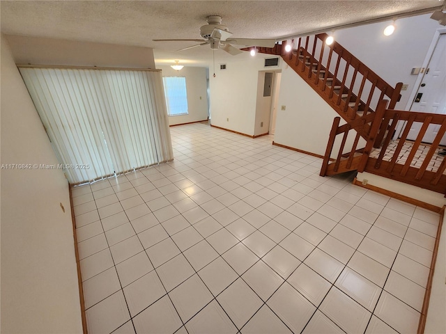 interior space featuring ceiling fan and a textured ceiling