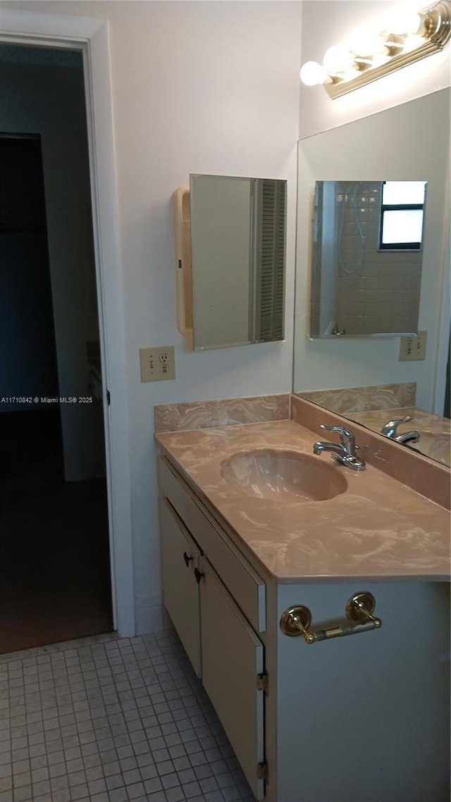 bathroom featuring tile patterned flooring and vanity