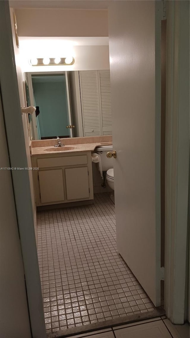 bathroom with tile patterned floors, vanity, and toilet