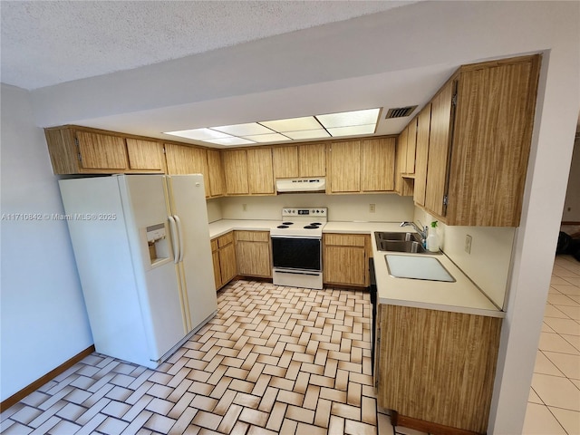 kitchen featuring range with electric stovetop, white fridge with ice dispenser, a textured ceiling, and sink