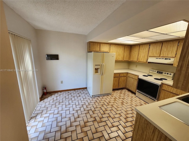 kitchen featuring sink, white appliances, a textured ceiling, and extractor fan