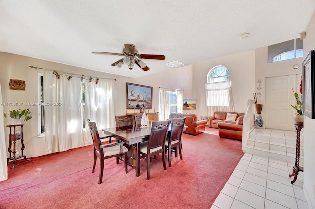 dining room featuring ceiling fan, light tile patterned floors, and a textured ceiling