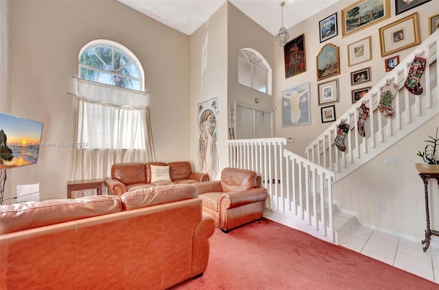 tiled living room with a high ceiling