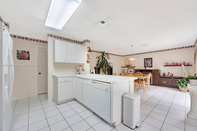 kitchen featuring kitchen peninsula, pendant lighting, a textured ceiling, white appliances, and white cabinets