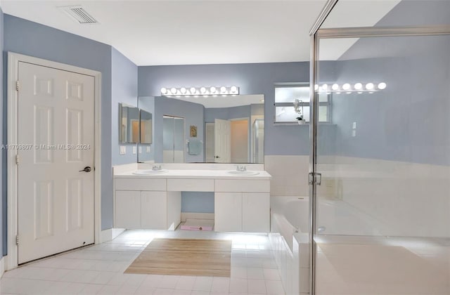 bathroom featuring tile patterned floors, vanity, and shower with separate bathtub