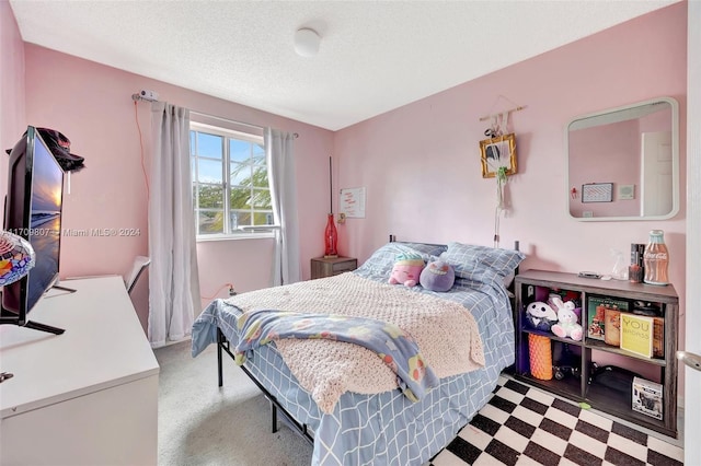 carpeted bedroom with a textured ceiling