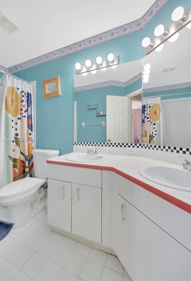 bathroom featuring walk in shower, tile patterned flooring, vanity, and toilet