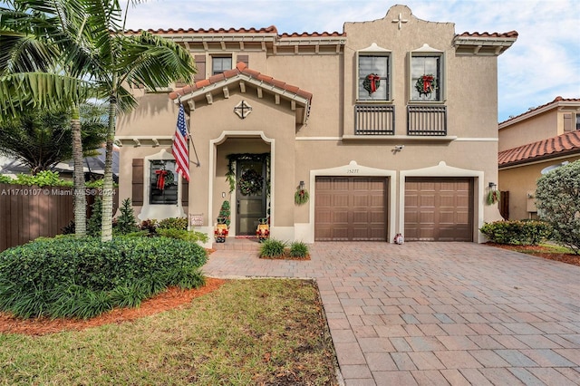 mediterranean / spanish home with a garage