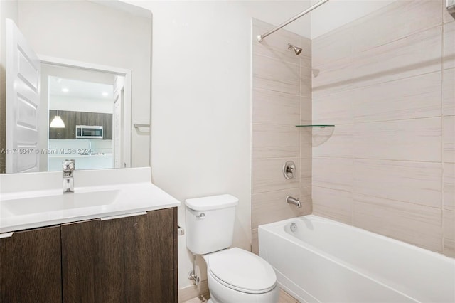 full bathroom with vanity, toilet, and tiled shower / bath