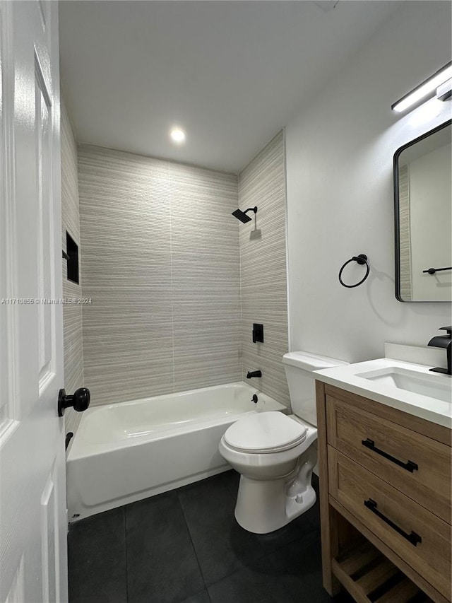 full bathroom featuring tile patterned floors, vanity, tiled shower / bath combo, and toilet