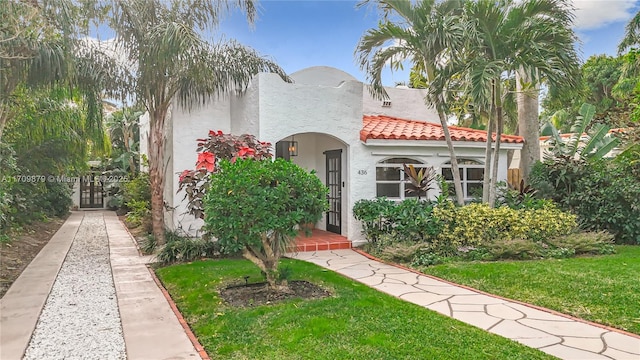 mediterranean / spanish-style home with a front yard