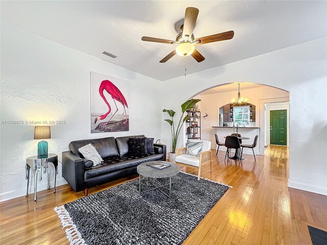 interior space featuring ceiling fan with notable chandelier and a textured ceiling