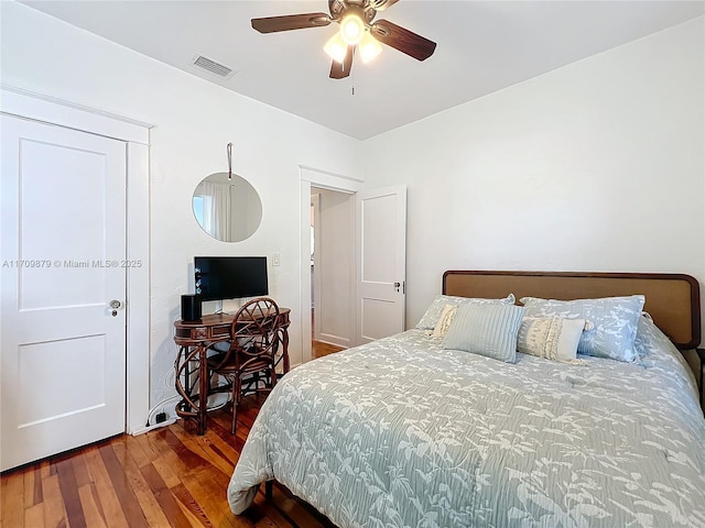 bedroom featuring dark hardwood / wood-style floors and ceiling fan