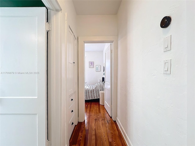 corridor with dark wood-type flooring