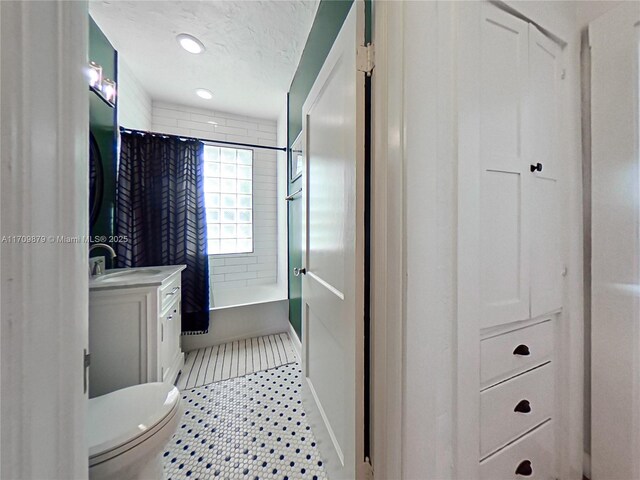 full bathroom with vanity, toilet, and shower / bathtub combination with curtain