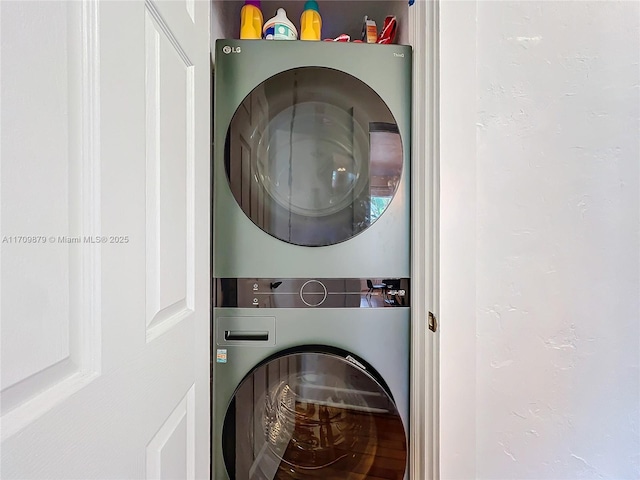 laundry area with stacked washer and dryer