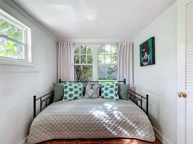 bedroom featuring crown molding and multiple windows