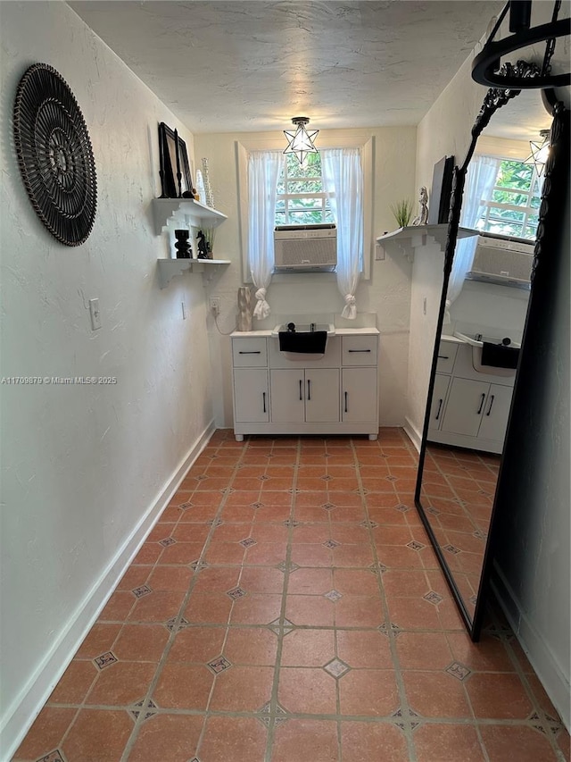 kitchen featuring white cabinets and light tile patterned flooring