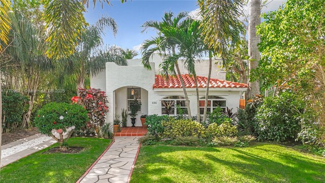 mediterranean / spanish-style house with a front lawn