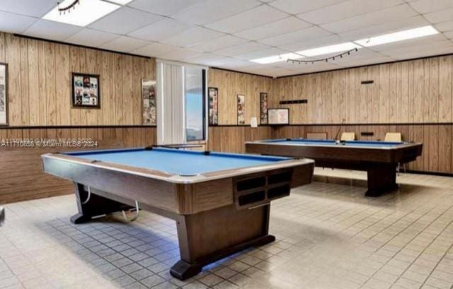 playroom with a drop ceiling, billiards, and wooden walls