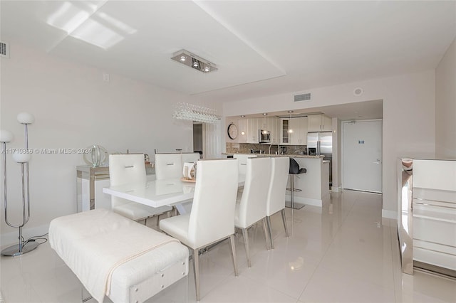 dining area with light tile patterned flooring