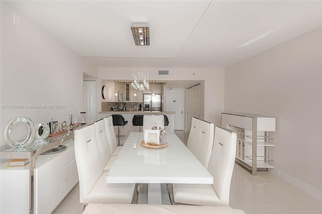 dining space featuring light tile patterned floors