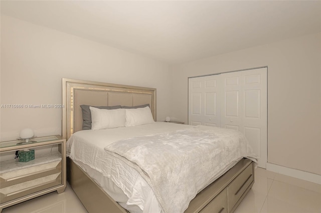 bedroom featuring light tile patterned floors and a closet