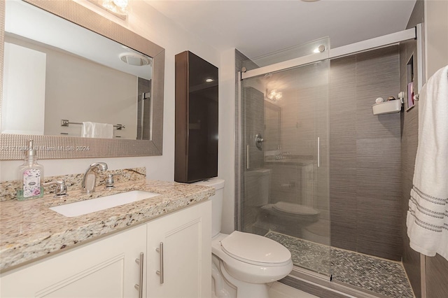 bathroom with vanity, toilet, and walk in shower