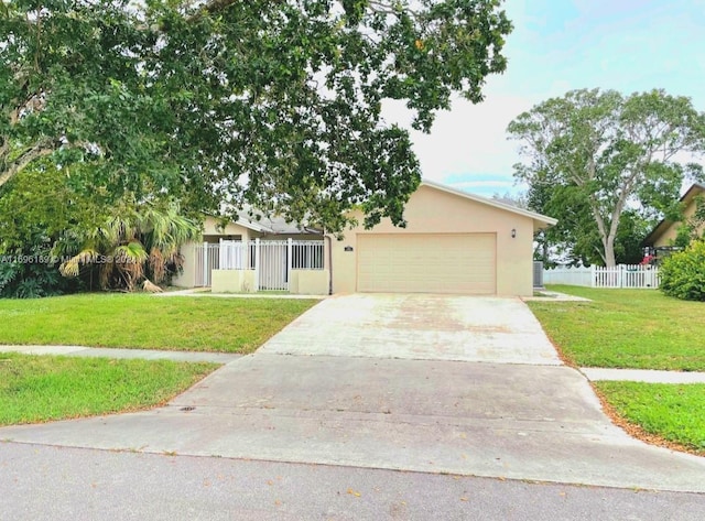 ranch-style house with a garage and a front lawn