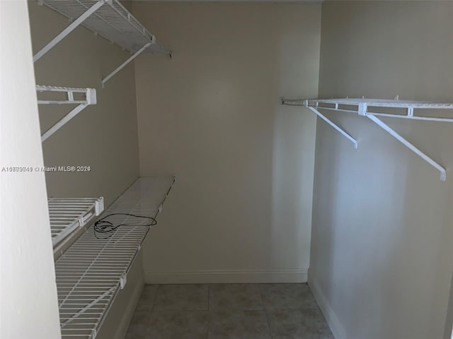 spacious closet featuring tile patterned flooring