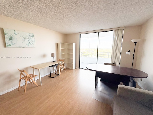 office space featuring light hardwood / wood-style floors and a textured ceiling