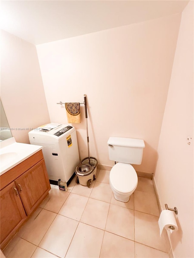 bathroom featuring tile patterned floors, vanity, and toilet