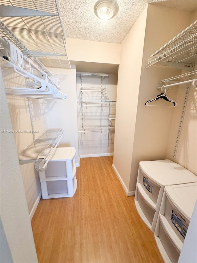 spacious closet with hardwood / wood-style floors