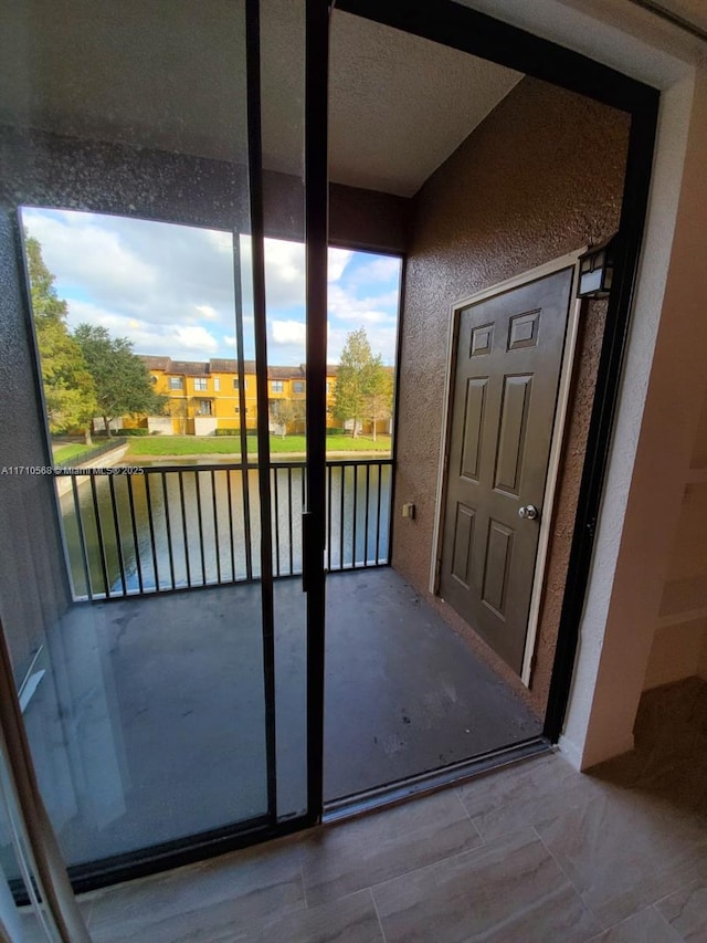 unfurnished sunroom with a water view