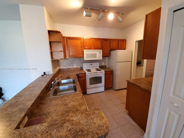 kitchen with white appliances, light tile patterned floors, open shelves, a sink, and brown cabinets