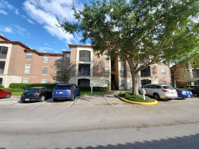 view of building exterior featuring uncovered parking